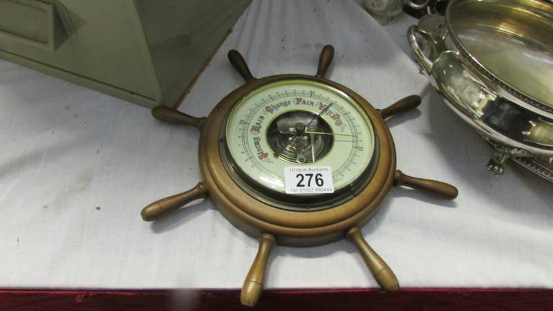 A ships wheel barometer.