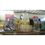 A shelf of assorted glass ware.