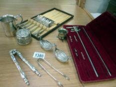 A quantity of silver plate items including sugar tongs,