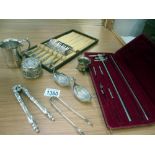 A quantity of silver plate items including sugar tongs,
