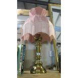 A brass table lamp with shade.