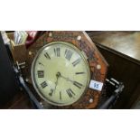 A wall clock with brass weights.