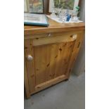 A pine single door cupboard.