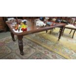 A mahogany extending dining table with one leaf.