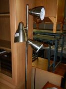 A brushed stainless steel floor standing lamp.