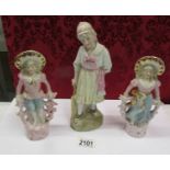 A pair of continental bisque figurines and one other.