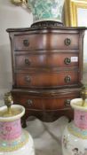 A small mahogany chest on stand.