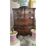 A small mahogany chest on stand.