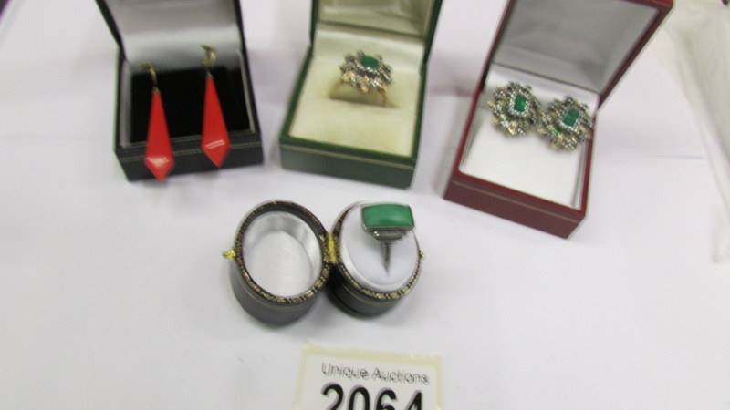 A green stone art deco ring in silver together with a pair of earrings with matching ring in yellow