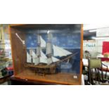 A cased HMS Bounty cutaway model ship.