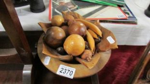 A mixed lot of wooden items including bowl, fruit etc.