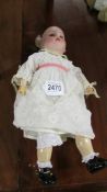 A German porcelain headed doll marked S H 1909 01/2.