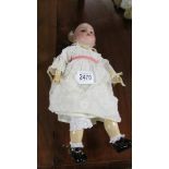 A German porcelain headed doll marked S H 1909 01/2.