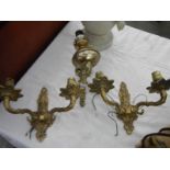 A pair of brass wall lights and one other.