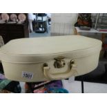 A small cream vintage vanity case