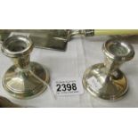 A small pair of silver candlesticks.