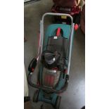 A Bosch battery lawn mower with battery and charger.
