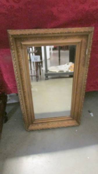 A gilt framed mirror.