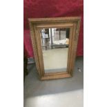 A gilt framed mirror.