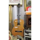 A Burswood classical style acoustic guitar.