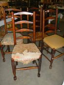 A set of 4 early 20th century oak ladder back chairs.