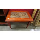 A coffee table with intricately carved inset.