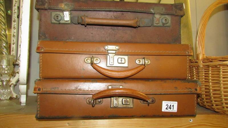 3 vintage suitcases.