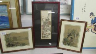 A pair of framed and glazed Japanese paintings on silk and one other.