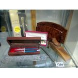 A selection of pens, walnut letter rack, frog door wedge etc.