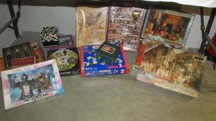 A mixed lot of jigsaw puzzles etc.