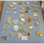 Approximately 35 assorted vintage brooches (display stand not included).