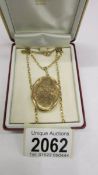 A gold locket dated 1989 with engraved front and plain back, attached 9ct gold chain, 11.9 grams.