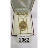 A gold locket dated 1989 with engraved front and plain back, attached 9ct gold chain, 11.9 grams.