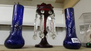 A pair of blue glass hand painted vases and a ruby glass lustre.