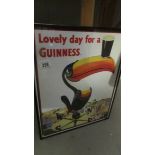 A framed and glazed Guinness advertisement.