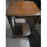 A 1930's oak side table with barley twist legs