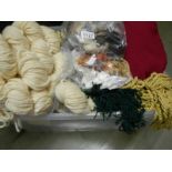 A box of tapestry threads, fringing and textile pieces.