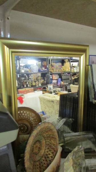 A gilt framed mirror.