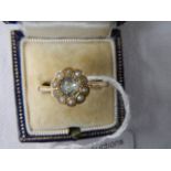 A 9ct gold ring set central stone surrounded by pearls, size T half.
