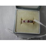 An 18ct gold diamond and ruby set ring, size K.