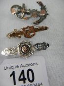 3 antique brooches - a 9ct rose gold designed as an archer within a shield, stamped 9ct,