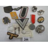 A quantity of replica German cloth and other cap badges etc.