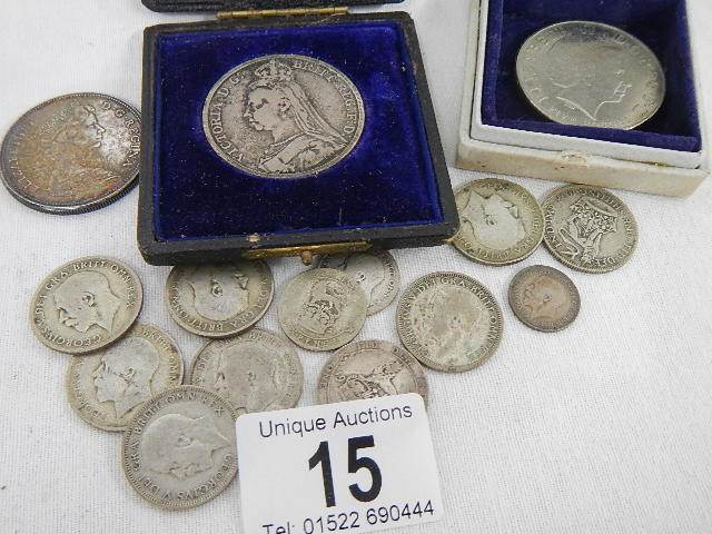 A quantity of silver coins and a Queen Elizabeth II £5 coin.