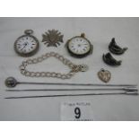 2 silver cased ladies watches, a silver fob, a silver locket on chain and a silver hat pin.