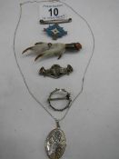 A quantity of silver items including claw brooch, enamel brooch etc.