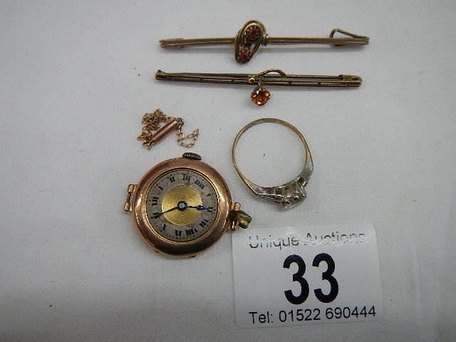 A 9ct gold ring size R Half, A gold ladies watch head, a small chain a/f and two brooches.