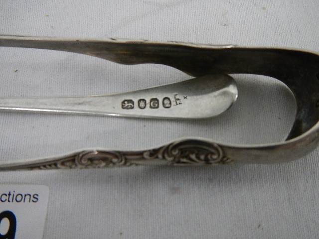 A silver spoon and silver sugar nips. ****Condition report**** Weight approx. - Image 3 of 4