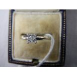 An 18ct white gold square set 4 stone diamond ring, size L half.