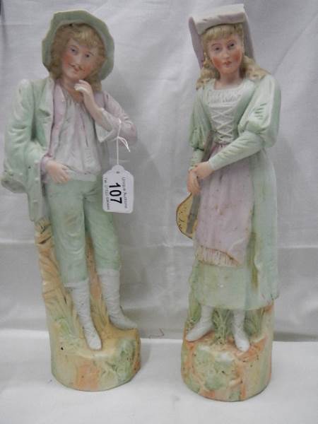 A pair of early 20th century bisque porcelain figures, 38 cm tall.