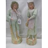 A pair of early 20th century bisque porcelain figures, 38 cm tall.